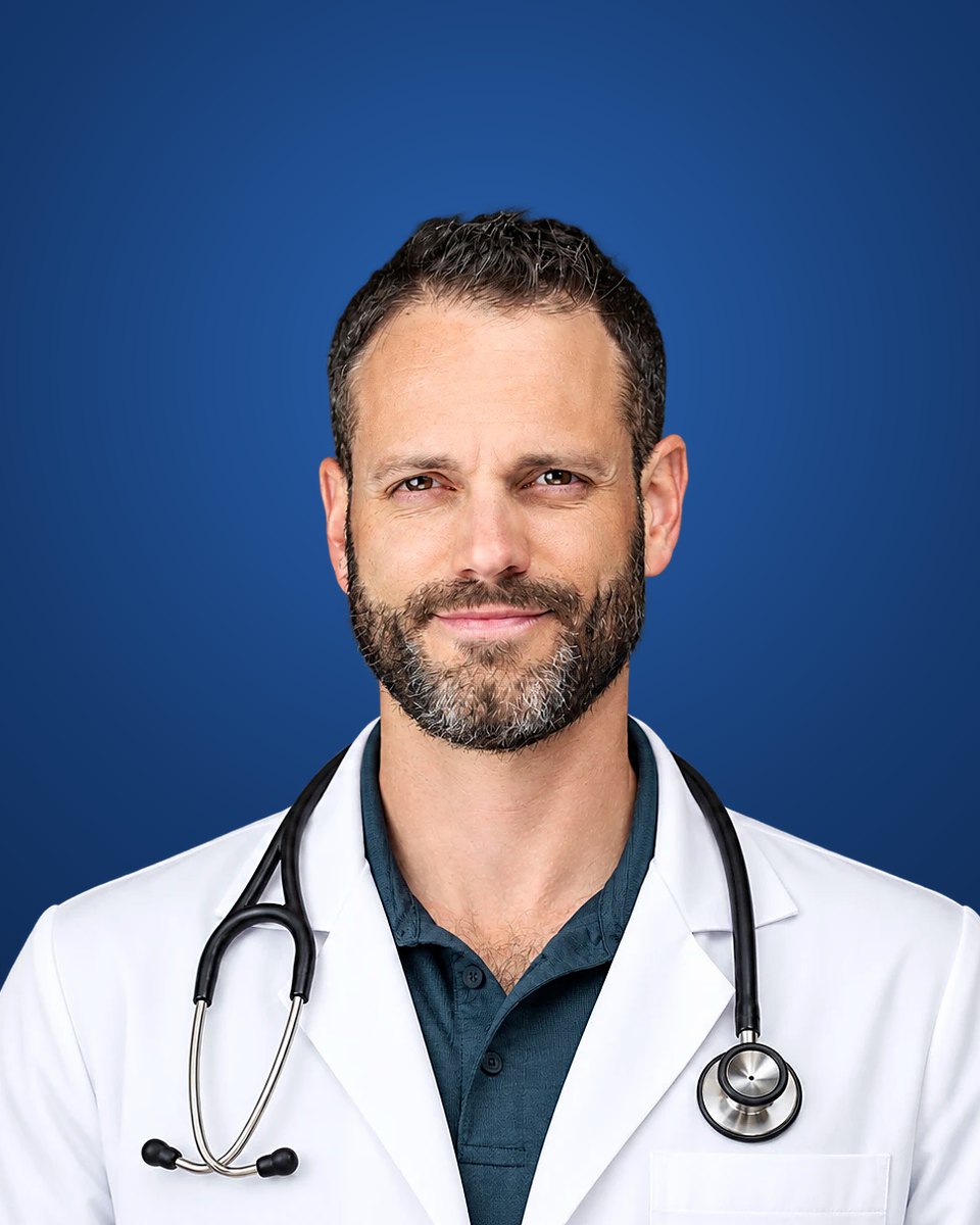 Dr. Sam Madeira, NMD, licensed naturopathic physician, in a white coat with a stethoscope
